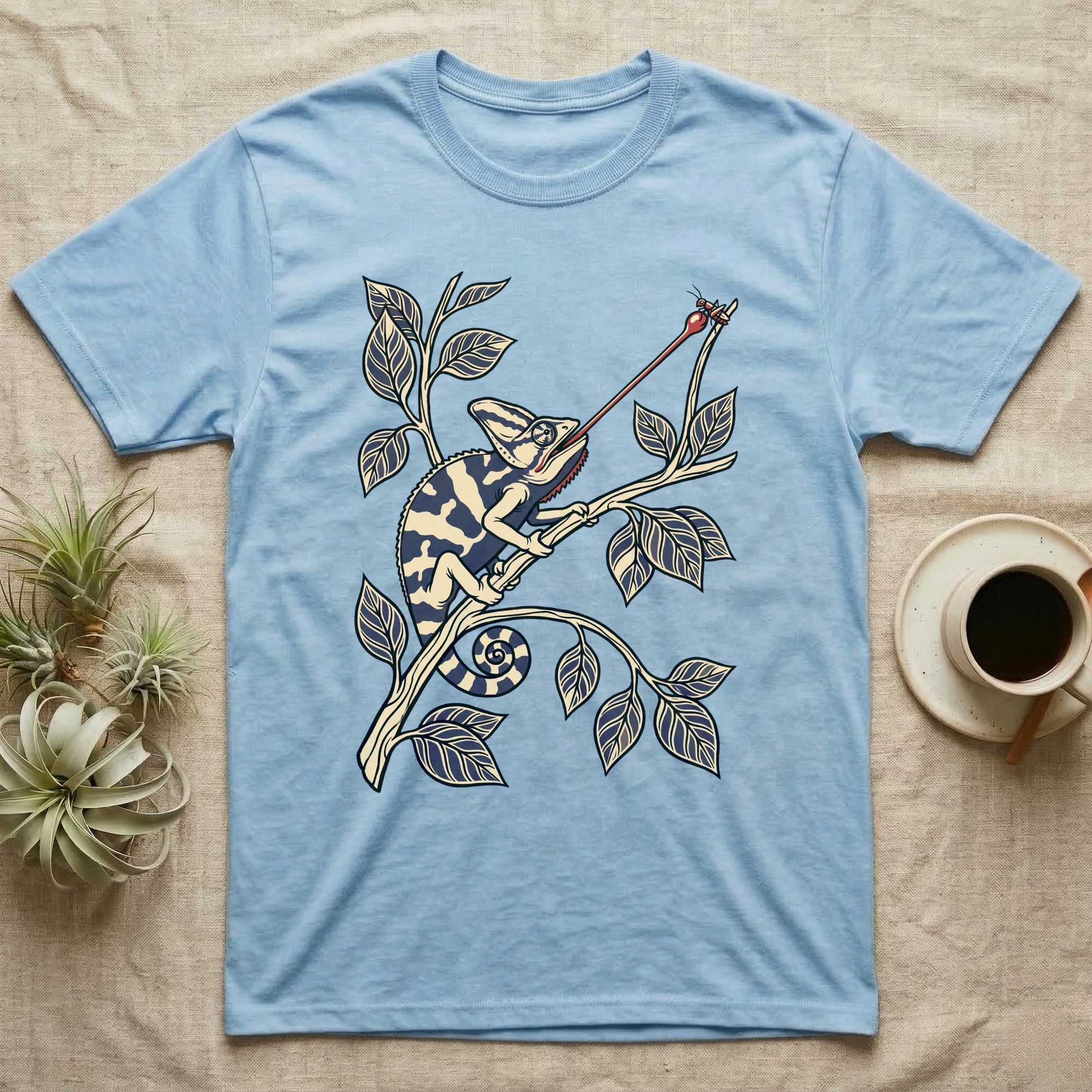 Veiled Chameleon The Strike T-Shirt in Light Blue — Ukiyo-e style woodblock illustration of a veiled chameleon mid-tongue-strike among foliage.