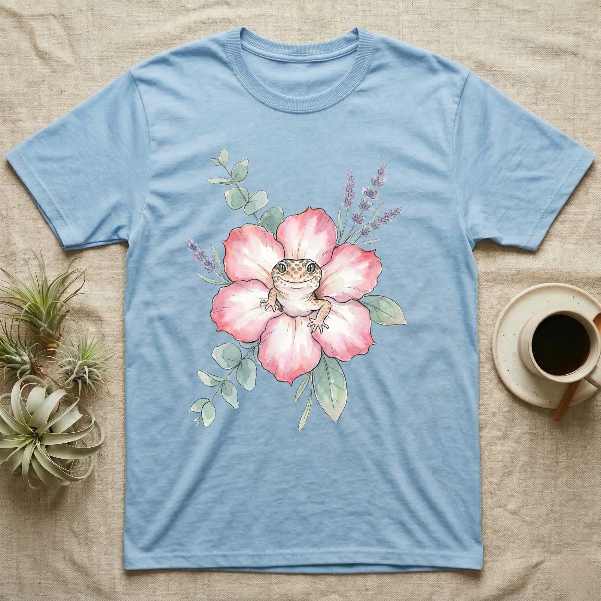 Light blue t-shirt with watercolor leopard gecko on a pink flower.