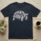 Sulcata Bleach Spatter T-Shirt in Navy — Sulcata tortoise marching to the right, head up and one scaly front leg mid-step, formed from pale bleach spatter on black.