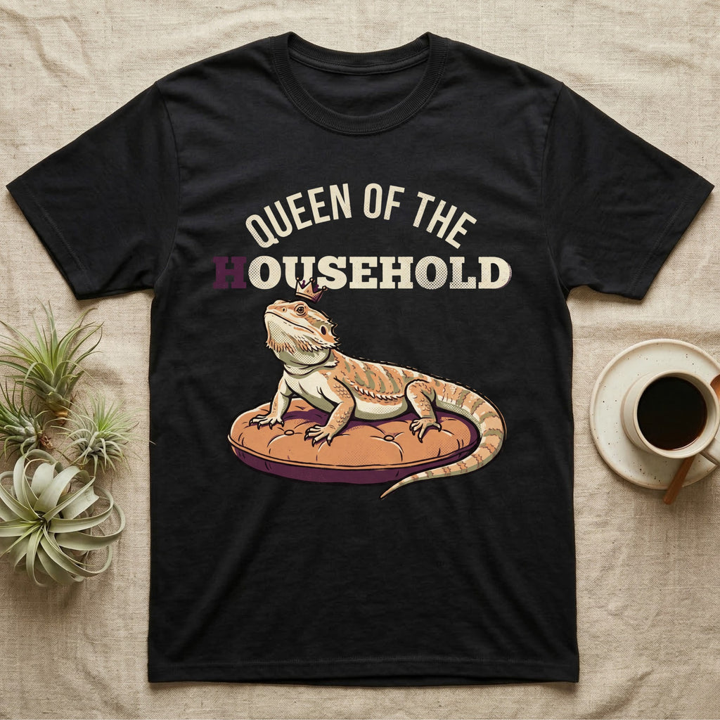Queen Bearded Dragon T-Shirt in Black — Bold-vector illustration of a bearded dragon on a throne-cushion with a crown under varsity Queen of the Household lettering.