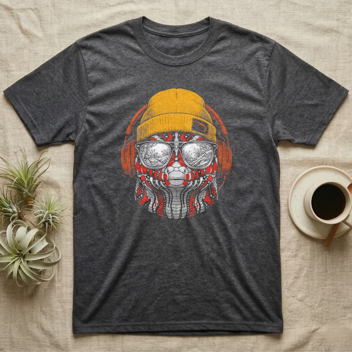 Fire Skink Headphones Groove T-Shirt in Dark Heather — Engraved fire skink with bold red-and-black scales in a beanie and headphones, aviators reflecting a jungle.