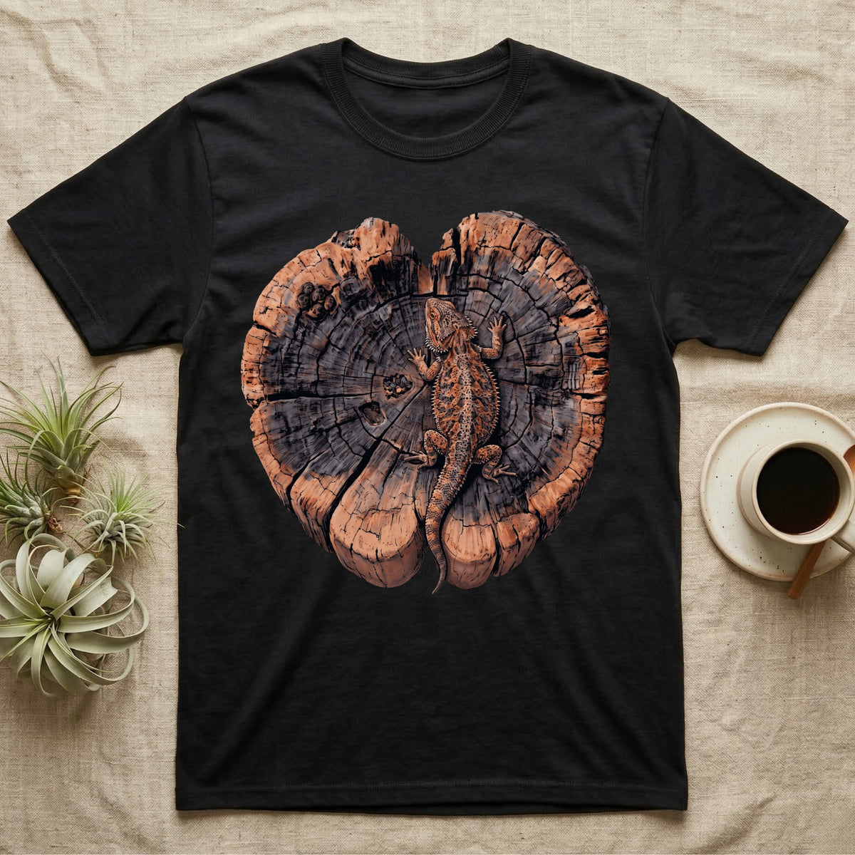 Bearded Dragon Basking Rings T-Shirt in Black — Top-down illustration of a bearded dragon splayed flat on a cross-section log slab of terracotta growth rings with bracket fungus, no on-shirt text.