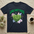Green Tree Python Feral T-Shirt in Navy — Green tree python in a saddle coil on a branch under a jagged emerald metal "LOOK DON'T TOUCH" wordmark and orchids.