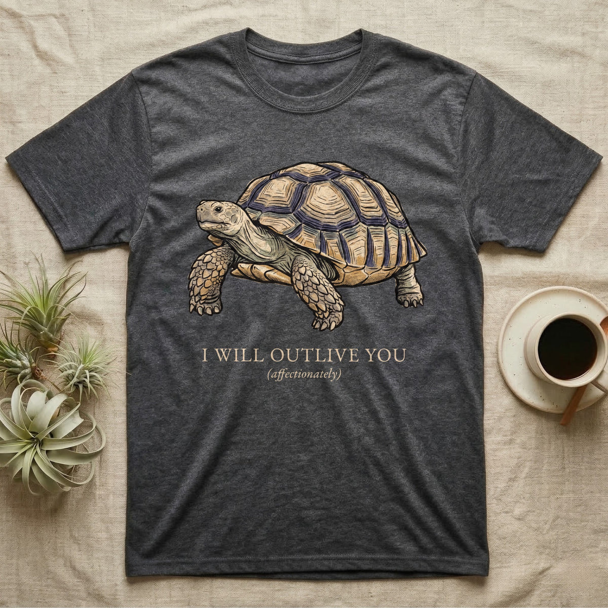 Sulcata Outlive You T-Shirt in Dark Heather — Ukiyo-e woodblock illustration of a sulcata tortoise in profile with a deadpan serif caption about outliving you.