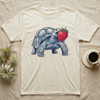 Sulcata Strawberry Tortoise T-Shirt in Natural — Bold vector illustration of a sulcata tortoise lunging neck-first toward an oversized red strawberry, head-on view.