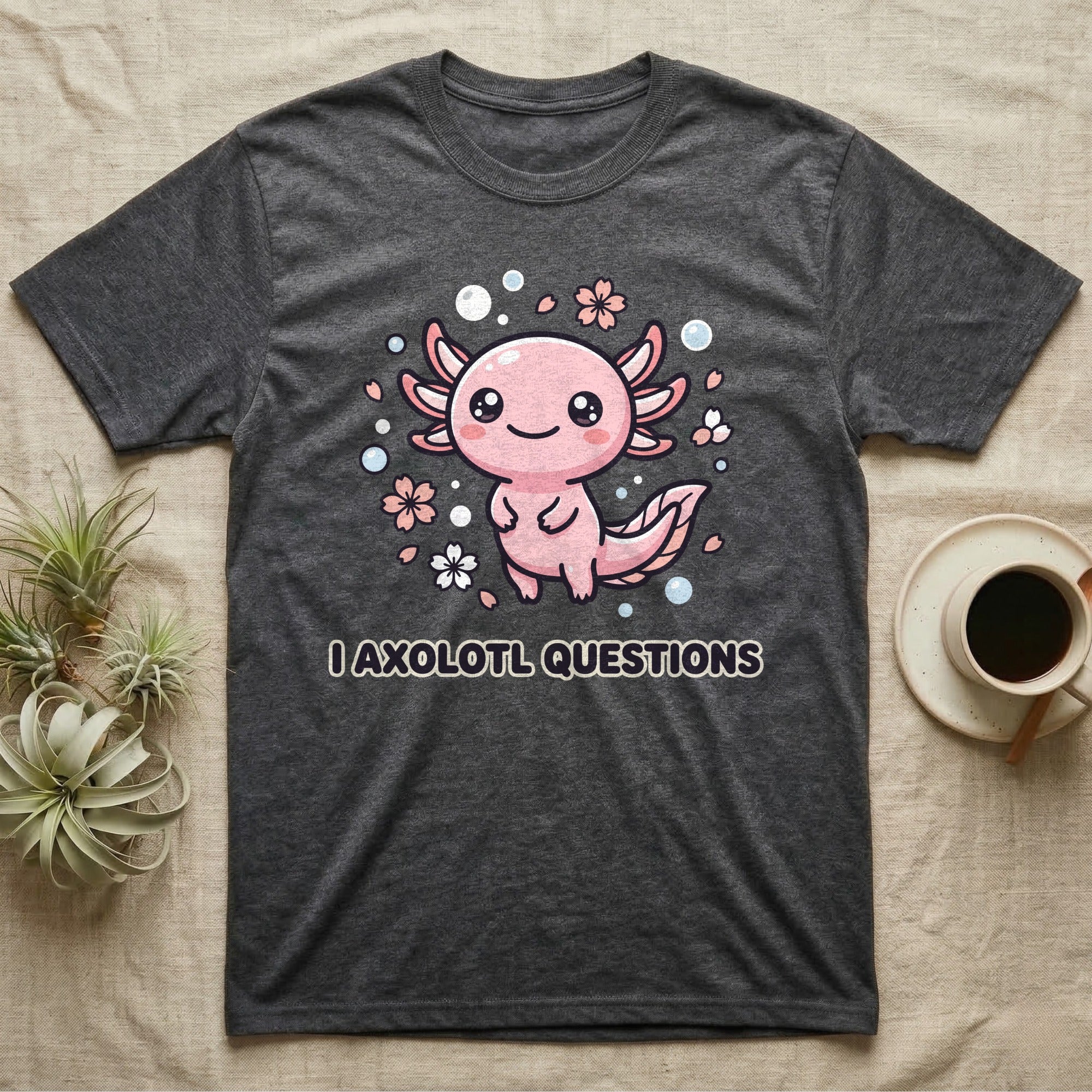 Dark t-shirt with cute axolotl illustration and "I axolotl questions" text.