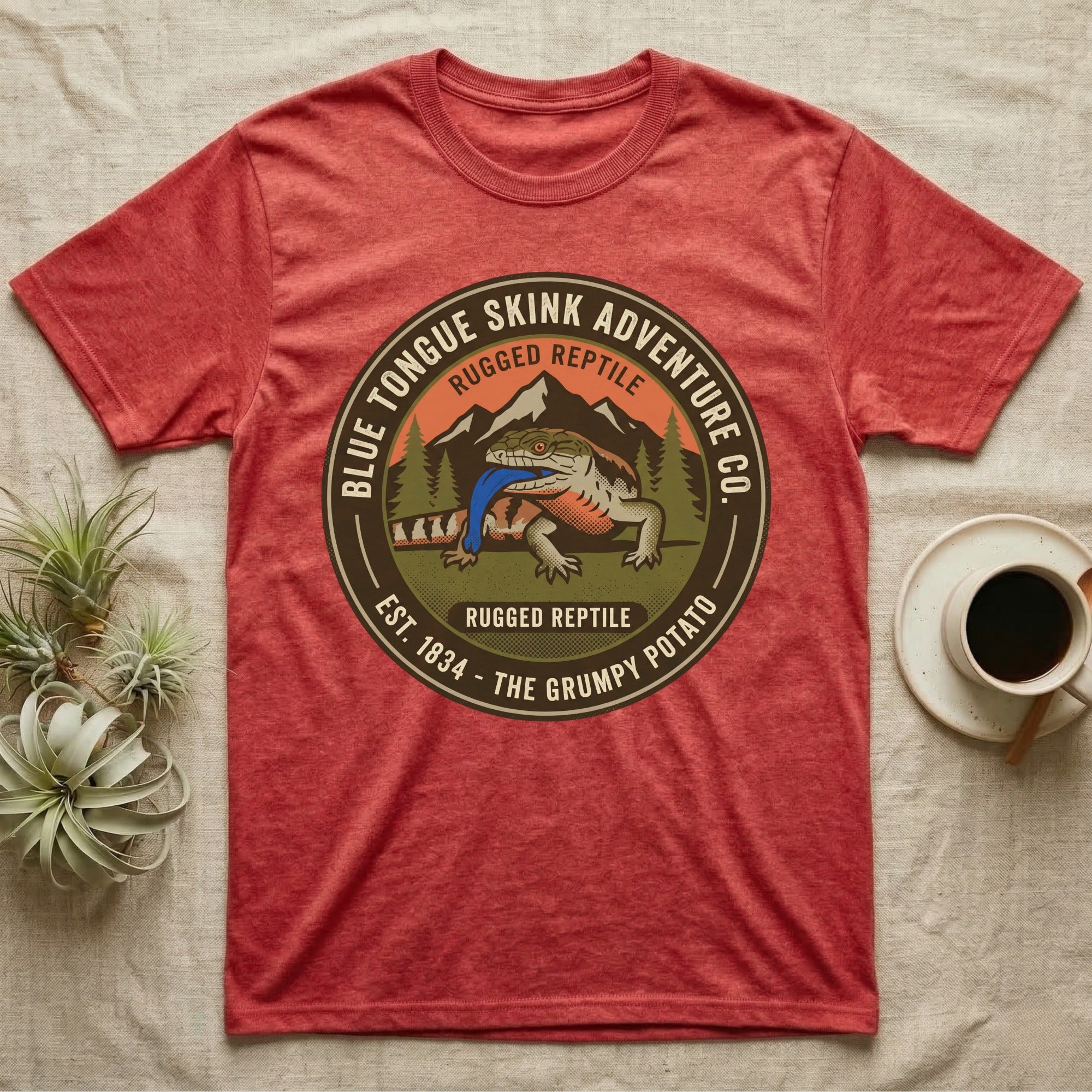 Red t-shirt with "Blue Tongue Skink Adventure Co." circular graphic featuring a lizard.