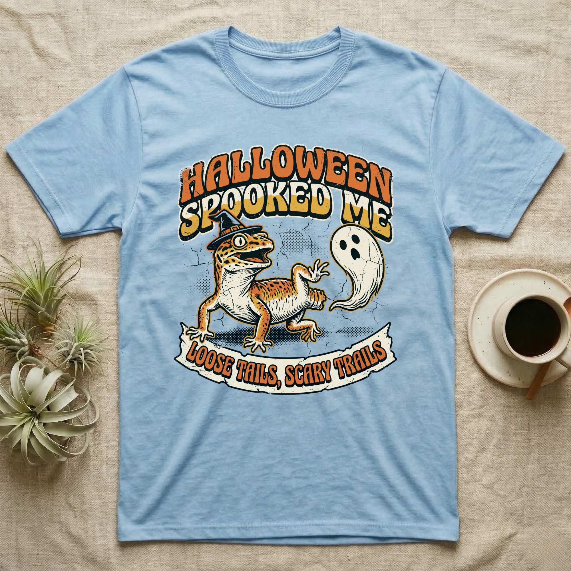 Leopard Gecko Spooked Me T-Shirt in Light Blue — Distressed graphic of a shocked leopard gecko in a witch hat beside its ghost-costumed dropped tail, "Halloween Spooked Me."