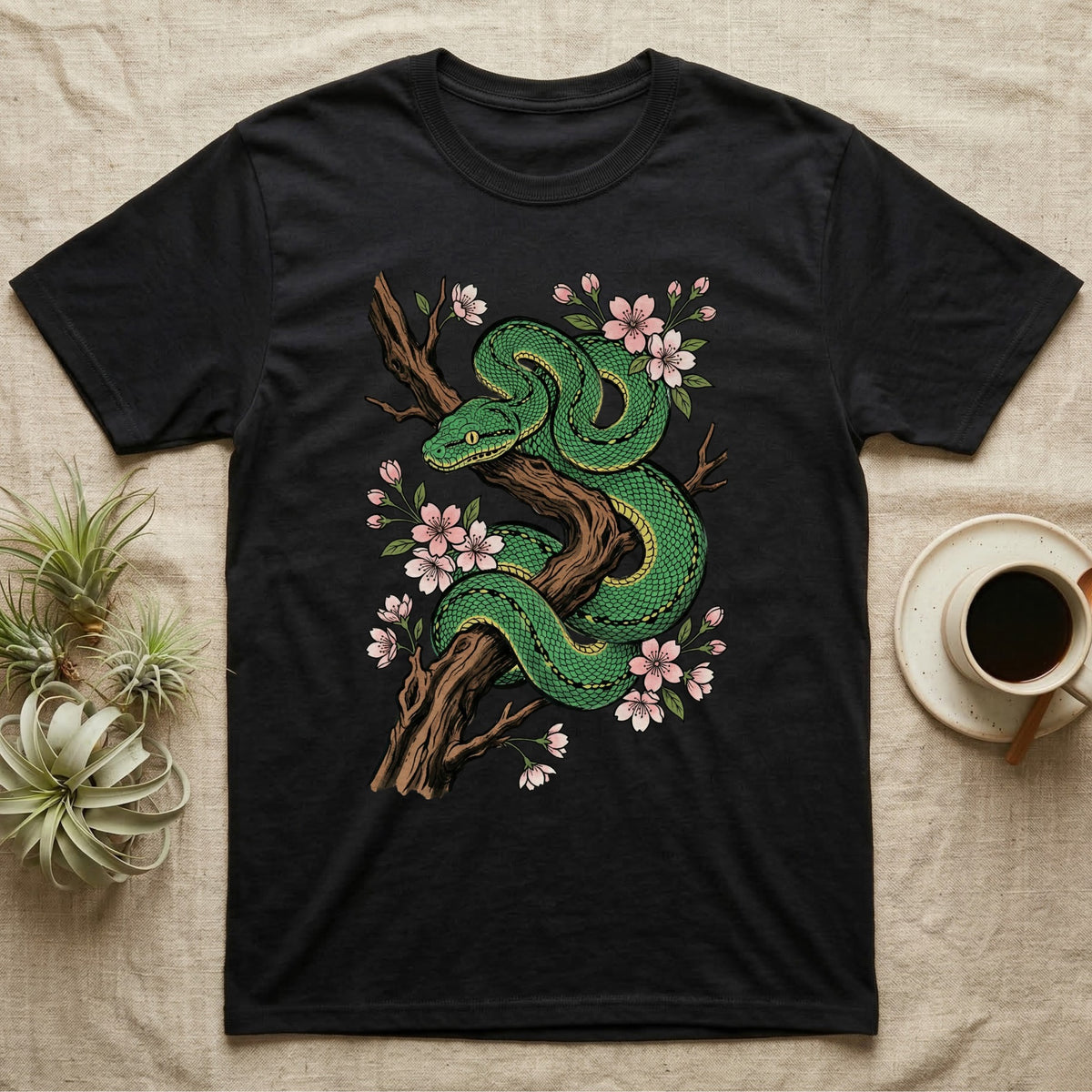 Black t-shirt with a green snake and pink flowers design.