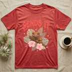 Crested Gecko Feral T-Shirt in Heather Red — Crested gecko on a mossy branch in a pastel jungle scene under a spiky coral metal wordmark reading SENDS IT.
