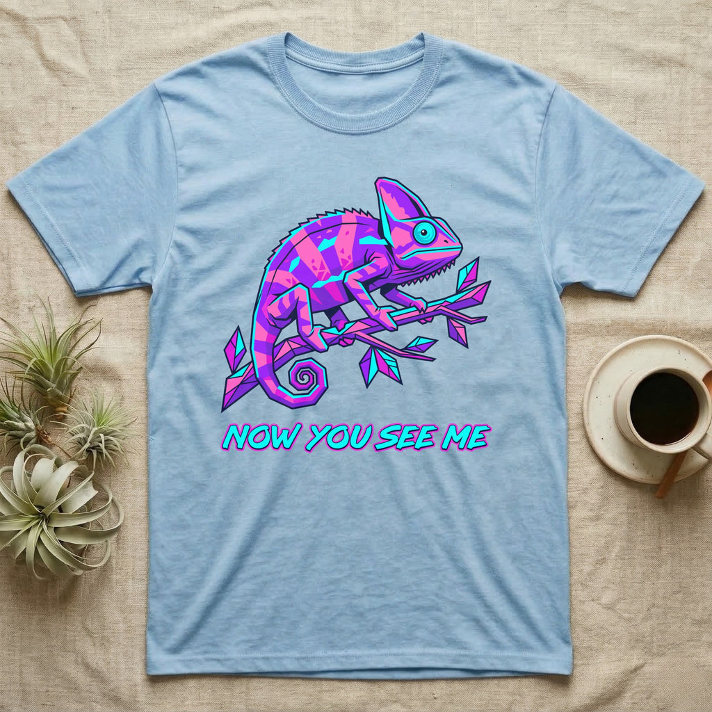 Light blue t-shirt with a neon chameleon and text "NOW YOU SEE ME".