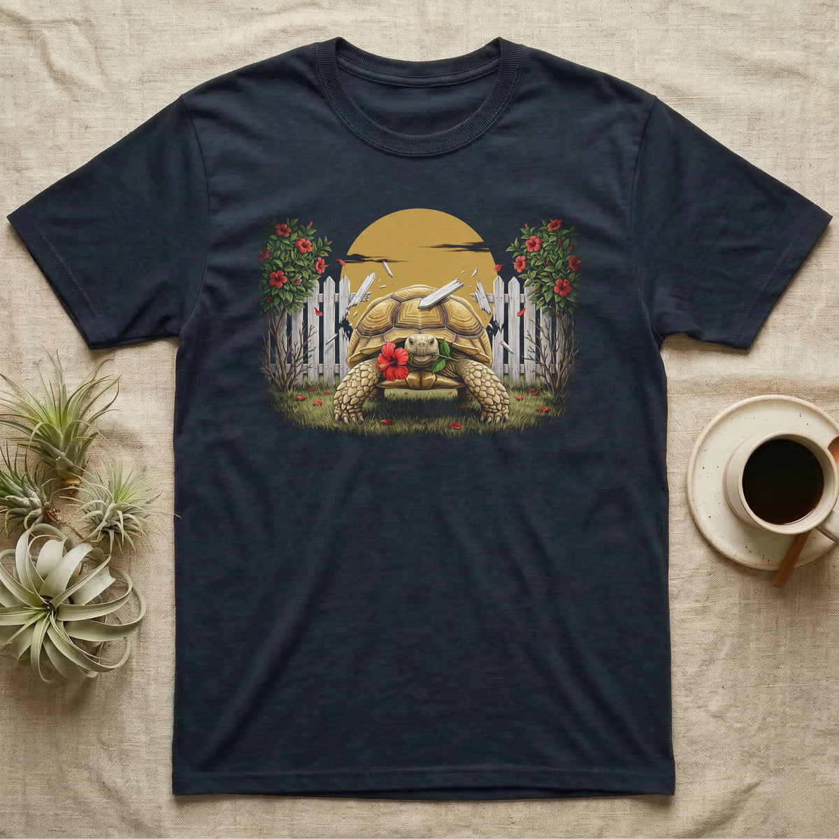 Sulcata Hibiscus Thief T-Shirt in Navy — Painted 90s wildlife art of a sulcata tortoise walking through a broken picket fence with a red hibiscus flower in its beak