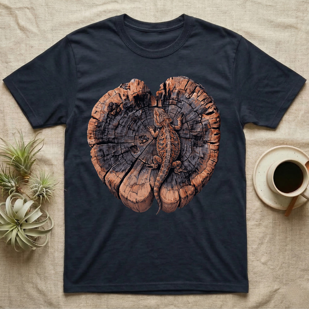 Bearded Dragon Basking Rings T-Shirt in Navy — Top-down illustration of a bearded dragon splayed flat on a cross-section log slab of terracotta growth rings with bracket fungus, no on-shirt text.