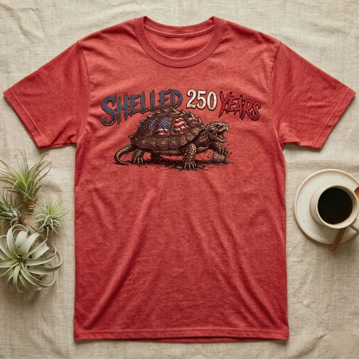 Snapping Turtle 250 T-Shirt in Heather Red — Gritty woodcut alligator snapping turtle with a flag-etched shell on a 250 coin under text Shelled 250 Years.