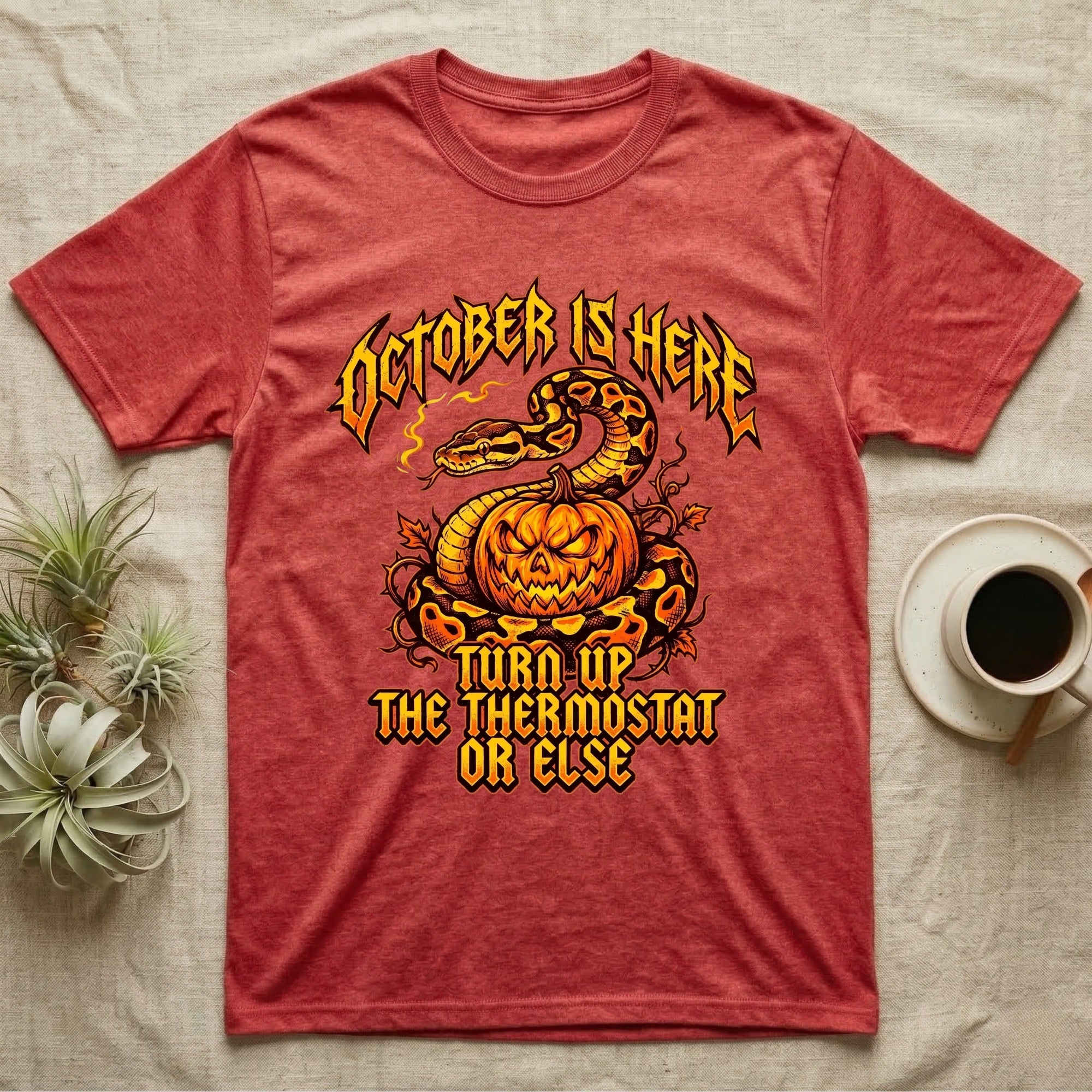 Ball Python October Thermostat T-Shirt in Heather Red — Metal-band style ball python coiled over a glowing jack-o'-lantern, "October Is Here, Turn Up the Thermostat Or Else."