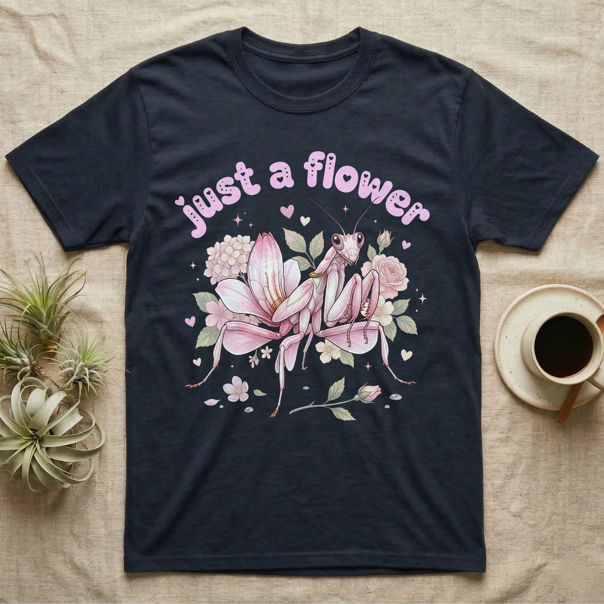 Orchid Mantis Softie T-Shirt in Navy — Pink orchid mantis mimicking a flower under pastel bubble text "just a flower" with tiny hearts.
