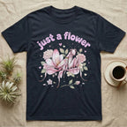 Orchid Mantis Softie T-Shirt in Navy — Pink orchid mantis mimicking a flower under pastel bubble text "just a flower" with tiny hearts.