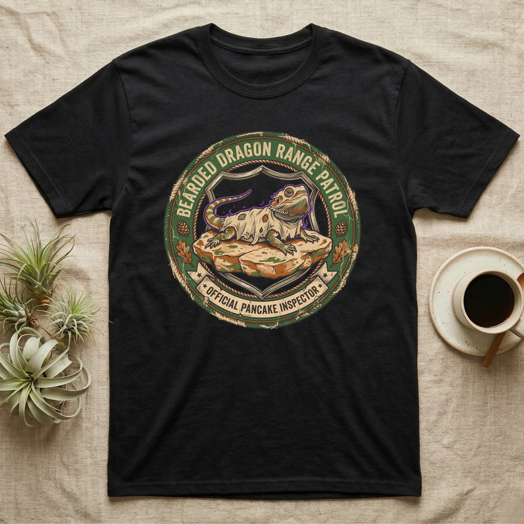 Bearded Dragon Pancake Inspector T-Shirt in Black — Weathered ranger badge of a bearded dragon flattened on a rock, "Bearded Dragon Range Patrol, Official Pancake Inspector."