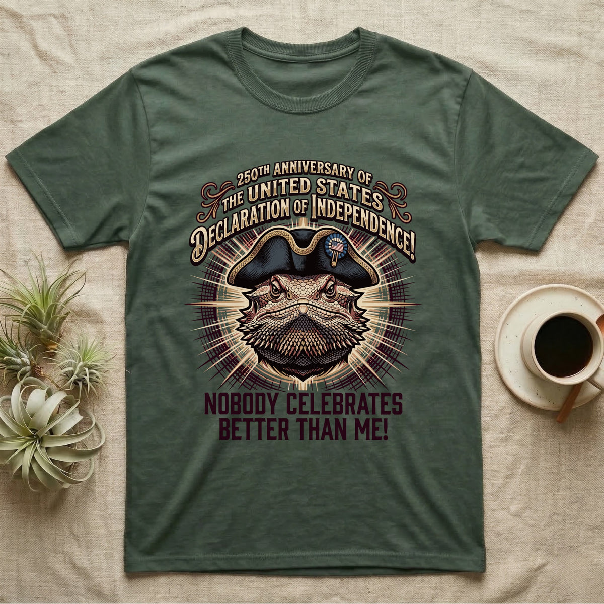 Bearded Dragon Declaration T-Shirt in Military Green — Ornate engraved bearded dragon portrait in a tricorn hat on a cream sunburst with Nobody Celebrates Better Than Me.