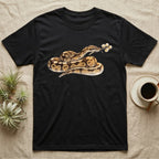 Ball Python Blossom T-Shirt in Black — Watercolor illustration of a tan-and-brown ball python holding an acacia blossom sprig, on a dark grey t-shirt.