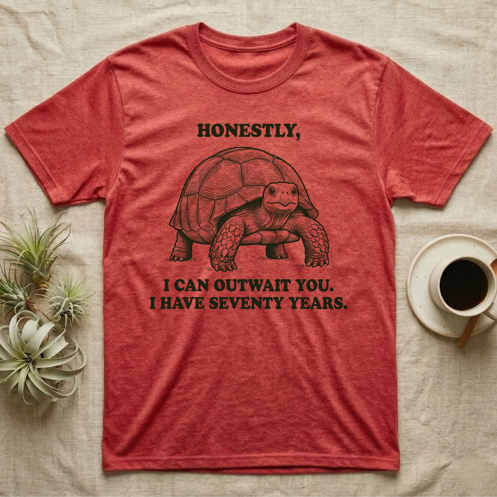 Sulcata Tortoise The Fence Lost T-Shirt in Heather Red — Block-print sulcata tortoise mid-stride in one terracotta ink, ringed by the words THE FENCE LOST and it was in my way.