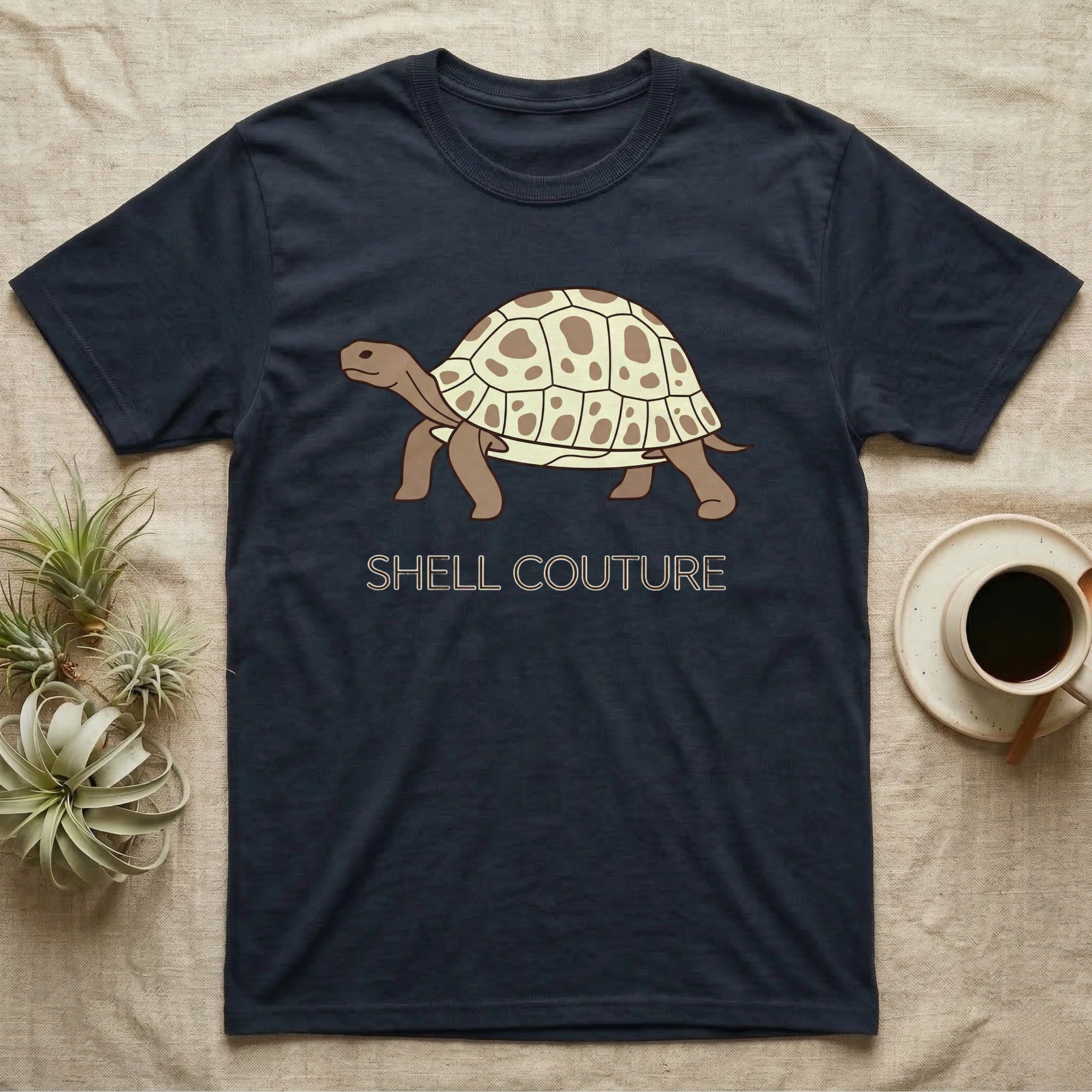 Dark blue t-shirt with a cartoon tortoise and "SHELL COUTURE" text.