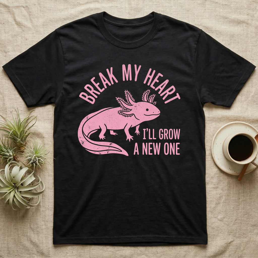 Axolotl Regrow T-Shirt in Black — Worn one-ink pink axolotl walking side-on, gills spread, under Break My Heart, I'll Grow a New One