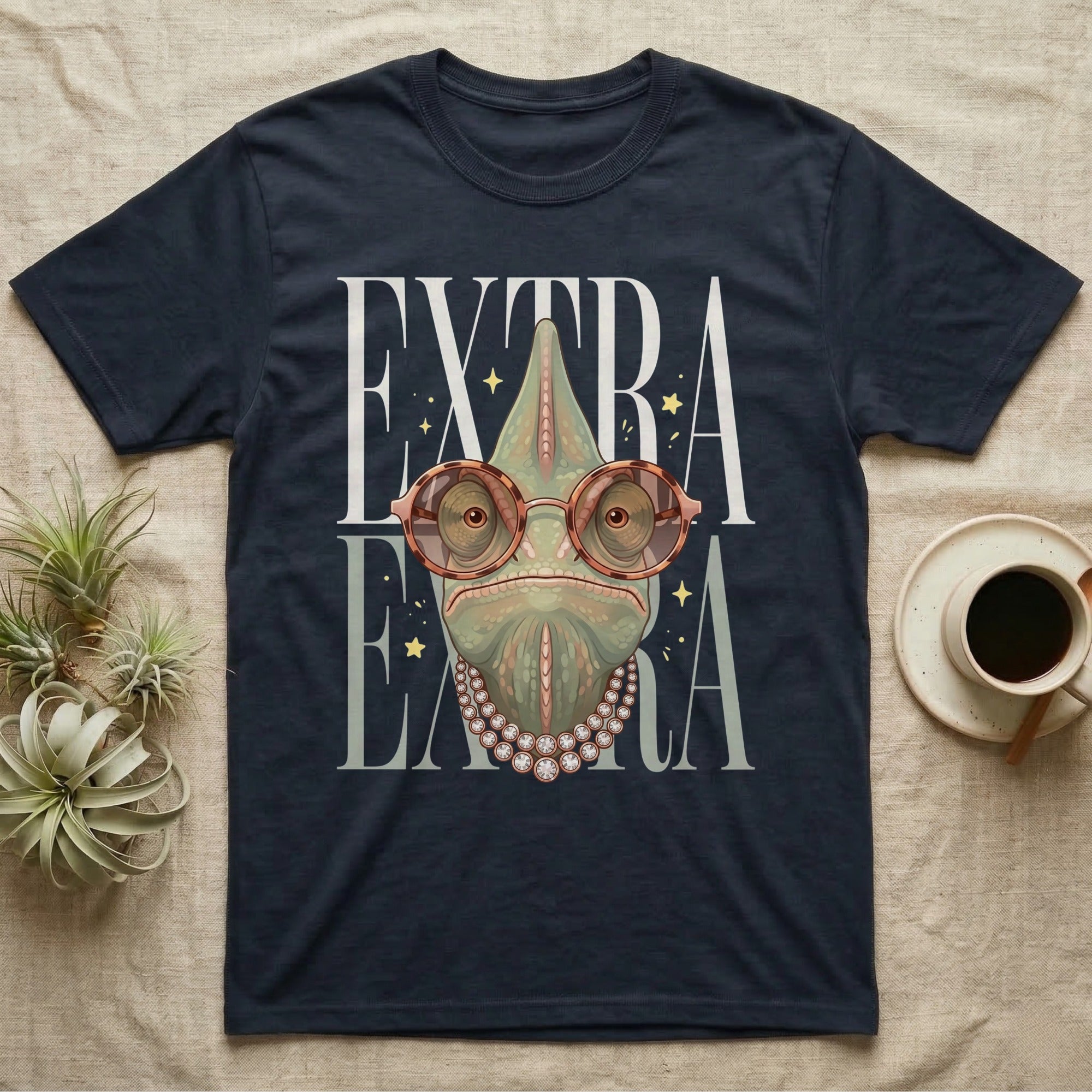 Dark t-shirt with "EXTRA EXTRA" text and a chameleon wearing sunglasses and pearls.