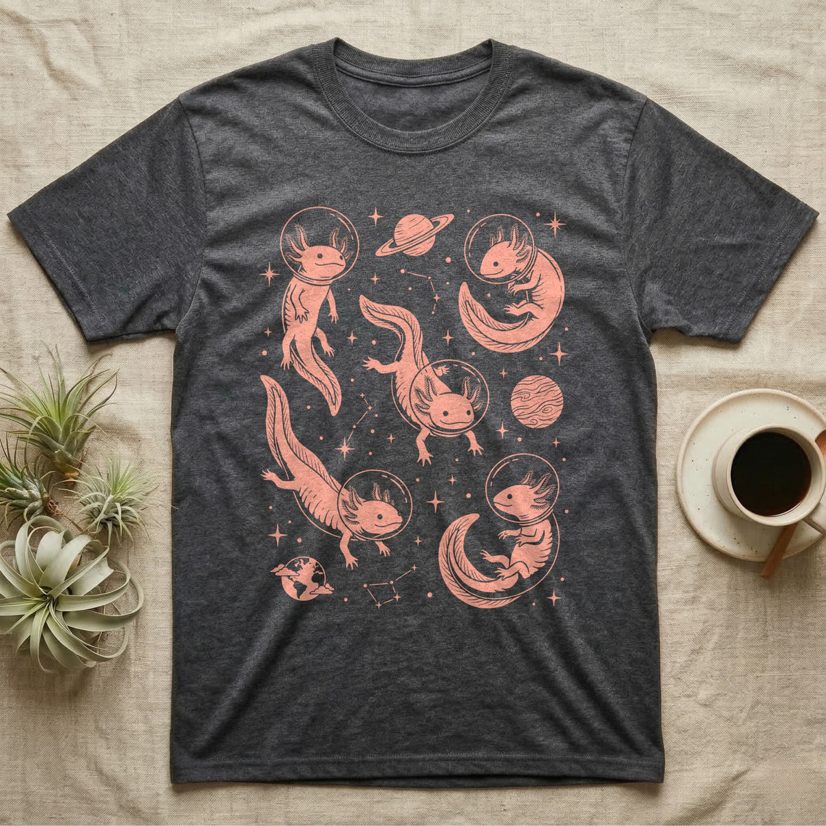 Axolotl Cosmic T-Shirt in Dark Heather — Vintage screen-print illustration of axolotls in astronaut helmets floating in space, soft coral monochromatic on dark background.