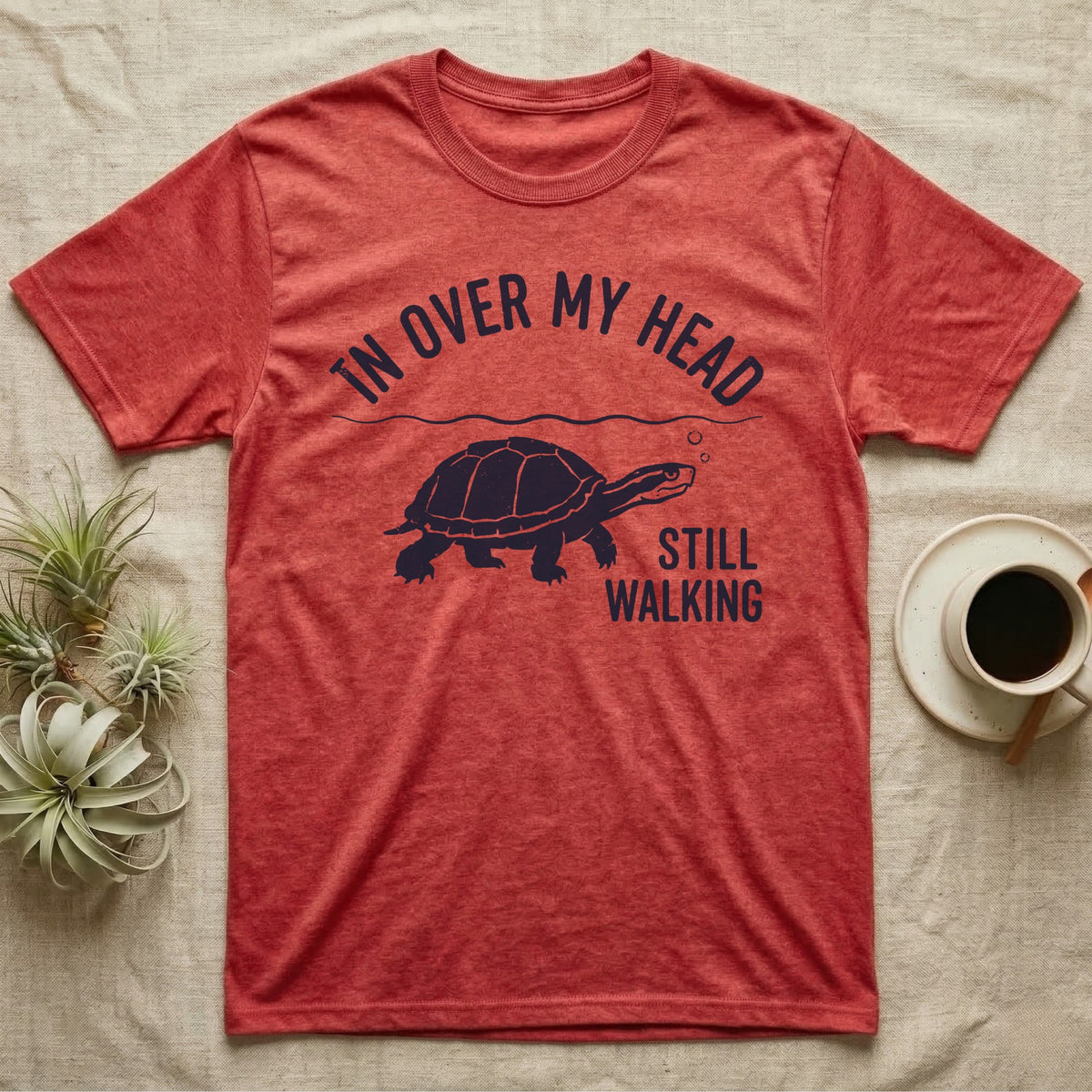 Musk Turtle Walking T-Shirt in Heather Red — Navy silhouette of a musk turtle walking under arched words In Over My Head, beside Still Walking