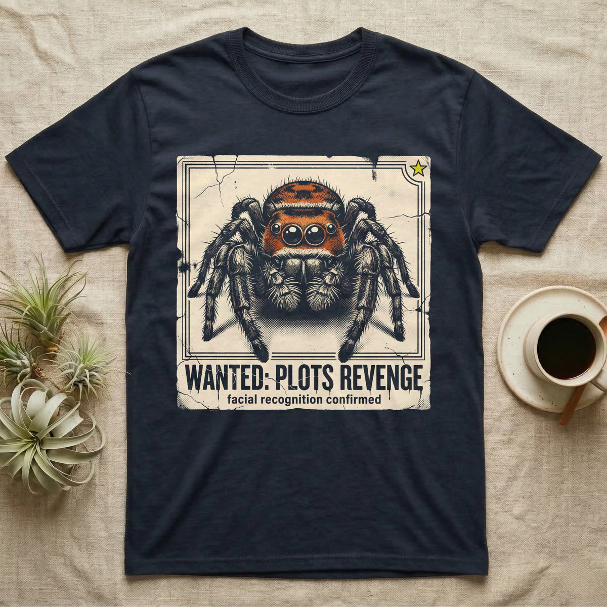 Jumping Spider Wanted T-Shirt in Navy — Distressed wanted-poster illustration of a front-facing jumping spider with the banner text plots revenge below.