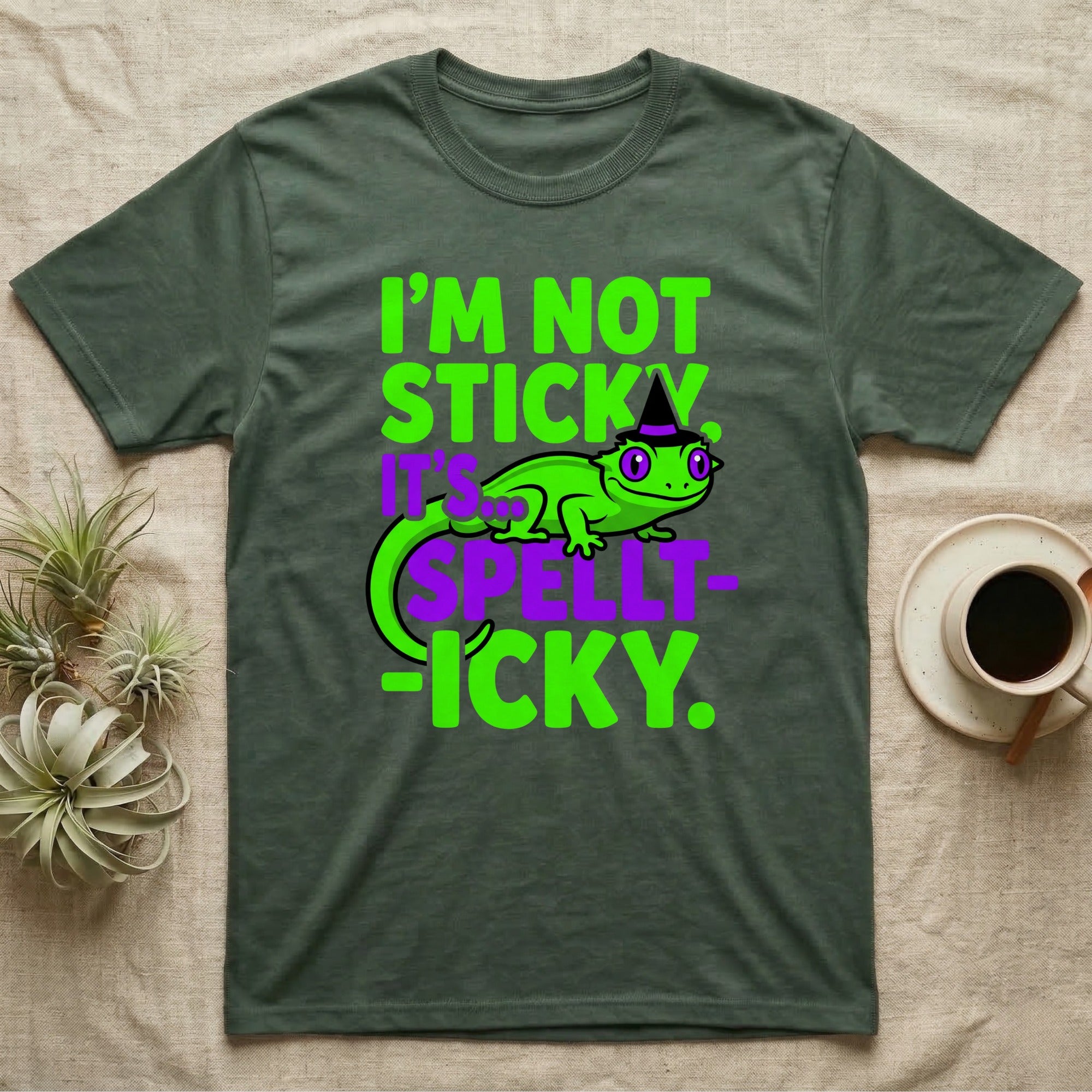 Crested Gecko Spellt-icky T-Shirt in Military Green — Neon cartoon crested gecko in a witch hat with stacked text, "I'm Not Sticky, It's Spellt-icky."