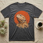 Bearded Dragon Orange Disc T-Shirt in Dark Heather — Bearded dragon bust in warm ochre breaking out of the lower edge of a flat distressed orange disc on grey